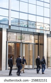 People Walking Past A Office Building