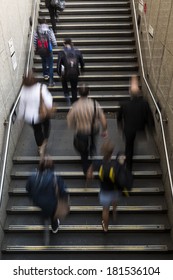 People walking up stairs with motion blur.