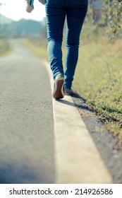 People Walking A Straight Line On The Road