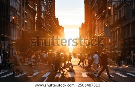 People walking through the busy intersection at 5th Avenue and 23rd Street in New York City on a summer day with sunset flare behind the background buildings
