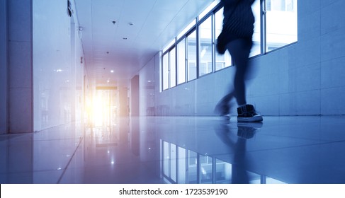 People Walking Through The Hospital Corridor.