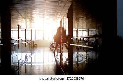 People Walking Through The Hospital Corridor.