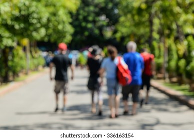 People walking tour on street,picture is blurred.