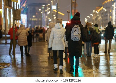 People Walking At The Winter Night Moscow Street. Back, Rear View. Illuminated The Capital Of Russian Federation.