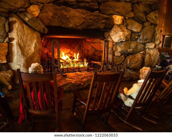 People Warming Themselves Around Huge Fireplace Stock Photo Edit