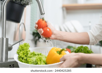 people washing raw vegetables at sink in the kitchen prepare ingredient for cooking - Powered by Shutterstock