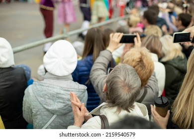 Lot Of People Watch Street Show. People At Street Rally. Russian Citizens On Extras. Spectators Stand In Row.