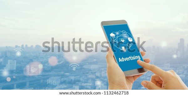 People watching ads on the screen of a\
smartphone. The concept of online\
advertising