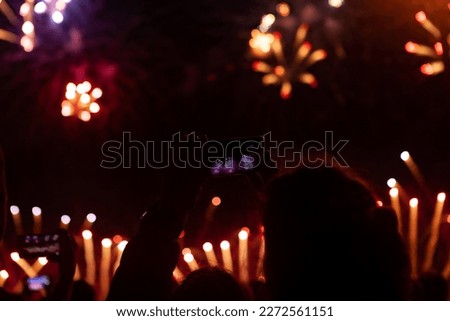 People watching fireworks. fireworks. woman taking the photo of fireworks by smartphone