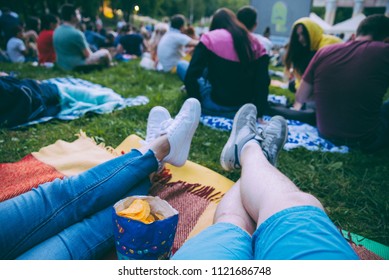 people watching movie in open air cinema in city park - Shutterstock ID 1121686748