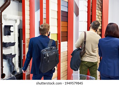 People Watching Vinyl Siding At An Exhibition In A Store