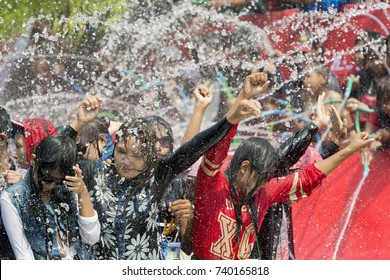People at the Waterparty at the Thingyan Water Festival at the Myanmar New Year in the city centre of Mandalay in Manamar in Southeastasia, yanmar,  mandalay, april, 2015..