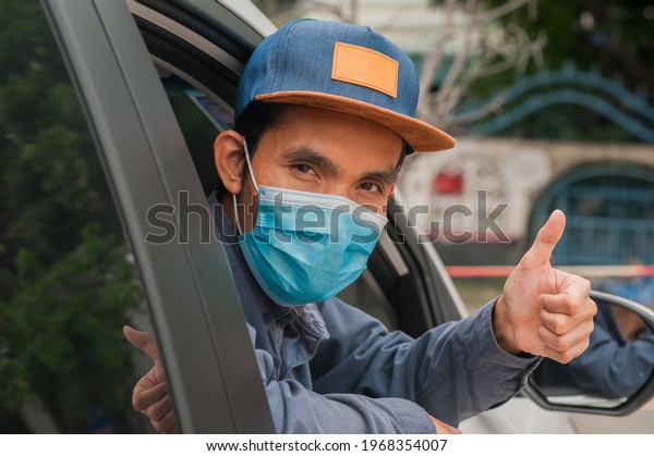 People wear face mask in car, Man\
wear medical mask in car , Mask protect covid19 coronavirus\
