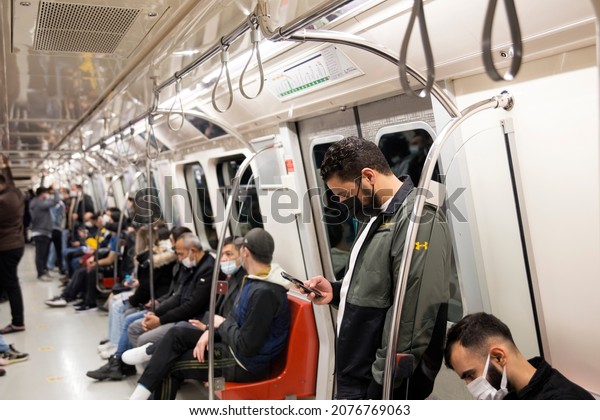The people wearing disposable medical face mask\
in car of the subway in İstanbul during coronavirus outbreak.\
Safety in a public place while epidemic of covid-19.  12, 11, 2021.\
istanbul, Turkey\
