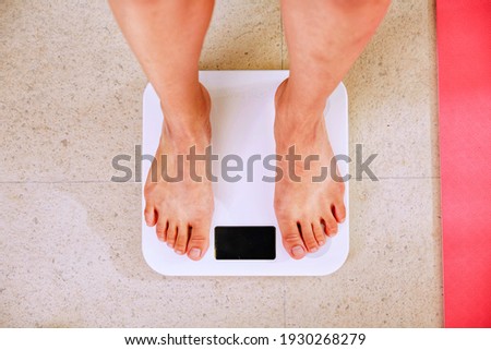 people weighing with a white digital scale