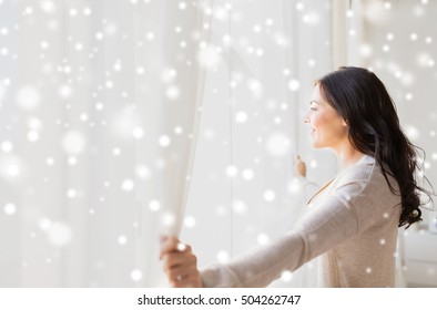 People, Winter, Christmas And Hope Concept - Close Up Of Happy Woman Opening Window Curtains