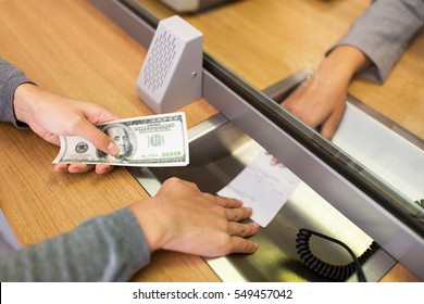 People, Withdrawal, Saving And Finance Concept - Customer With Cash Money Taking Receipt From Clerk At Bank Office Or Currency Exchanger