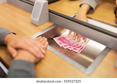 people, withdrawal, saving and finance concept - clerk giving cash money to customer at bank office or currency exchanger - Shutterstock ID 559527325