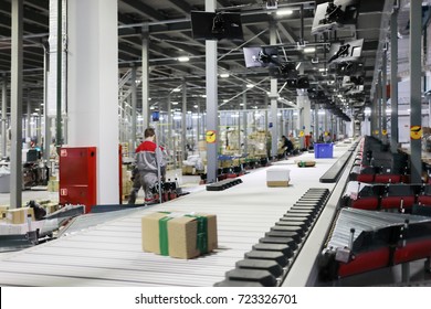 People work in modern workshop with conveyor, many displays in warehouse - Powered by Shutterstock