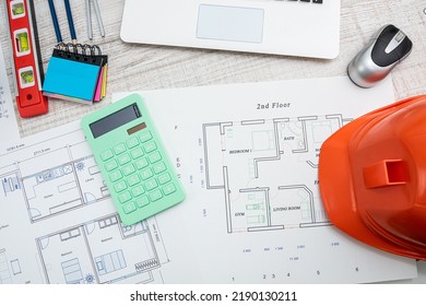 People Working With Construction Drawings And Tools At A Wooden Table. Top View Drawings With Tools