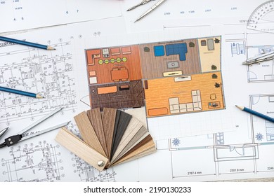 People Working With Construction Drawings And Tools At A Wooden Table. Top View Drawings With Tools