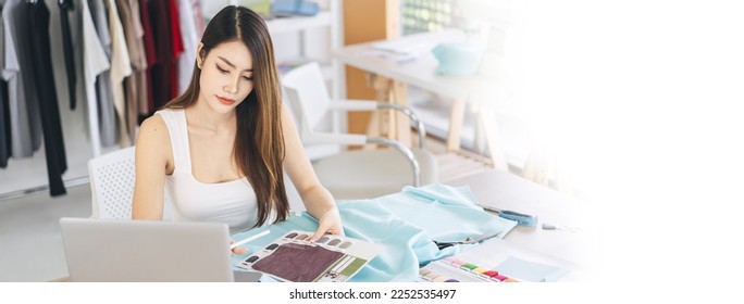 People working in fashion design concept. Young adult asian woman designer using laptop computer for online social media marketing. Banner size background. - Powered by Shutterstock