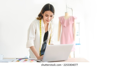 People working in fashion design concept. Young adult asian woman designer using laptop computer for online social media marketing. Banner size background. - Powered by Shutterstock