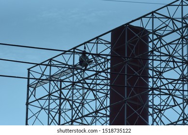 People Are Working On A Large Billboard Steel Frame.