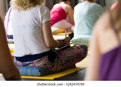 People Writing During A Yoga Retreat 