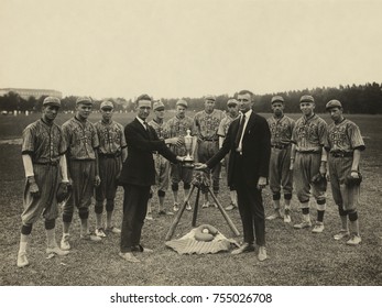 People's Drug Store Baseball Team Standing Pose With Their Trophy, 1921. The Washington, D.C. Amateur Teams Stands Behind A Symbolic Tableau Of Baseball Equipment As Two Men In Suits Exchange The Trop