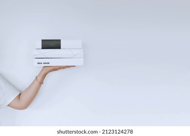 People's Hands Holding Stacks Of Books Isolated On White Background With Copy Space. World Book Day And Book Mockup Concept