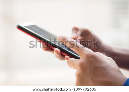 People's hands scrolling down on handphone's screen