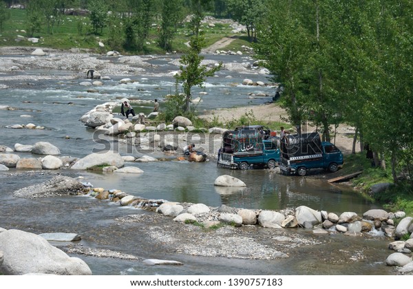 Peoples make a car wash in the\
stream, new silk route or Karakoram Highway(KKH), one belt one road\
(OBOR) path, Gilgit-Baltistan, Pakistan. 4/25/2014.\
\
\
