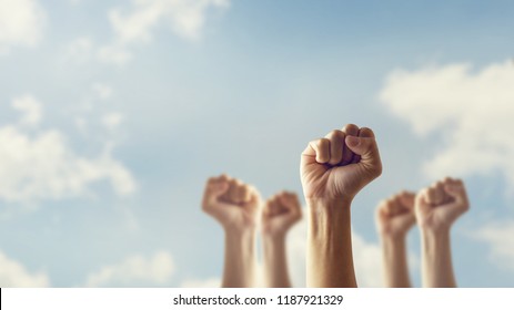 Peoples raised fist air fighting and sunlight effect, Competition, teamwork concept, background space for text. - Shutterstock ID 1187921329