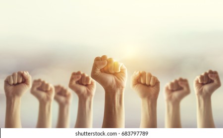 Peoples raised fist air fighting and sunlight effect, Competition, teamwork concept, background space for text. - Shutterstock ID 683797789