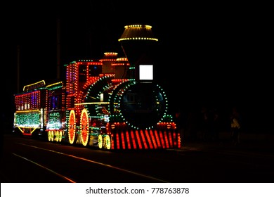 Peoplet Aking Photograph In Front Of Blackpool Train Of Lights