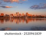 Peoria, Illinois, USA. Cityscape image of Peoria skyline, Illinois, USA with reflection of city lights in the Illinois River at autumn sunrise.