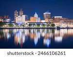 Peoria, Illinois, USA downtown skyline on the lake at dusk.