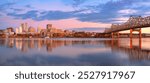  Peoria, Illinois, USA. Panoramic cityscape image of Peoria skyline, Illinois, USA with reflection of city lights in the Illinois River at autumn sunrise.