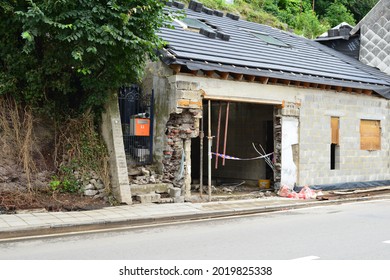 Pepinster, Belgium - August 1, 2021: 2 Weeks After The Flood. A House In Renovation. Roof Tiles Laying On The Saddle Roof. Only The Gutter Had To Be Finished, Support Beams Keeps House Straight.