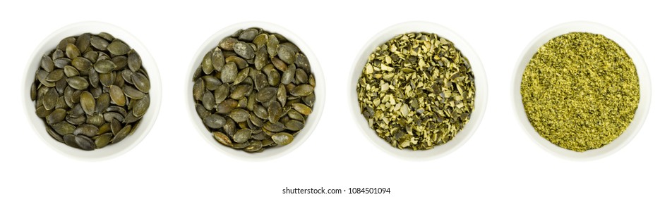 Pepita Pumpkin Seeds In White Porcelain Bowls. Raw, Roasted, Chopped And Ground. Flat Green Summer Squash Seeds Of Cucurbita Pepo, Genus Cucurbita. Isolated Food Photo, Close Up From Above Over White.