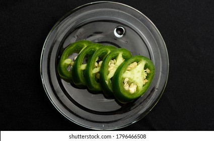 Jalapeño Pepper Cut Into Slices And Placed On A Transparent Glass Plate