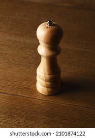 Pepper Grinder On A Wooden Table. Wooden Pepper Grinder. Close Up. Space For Text. Copy Space.