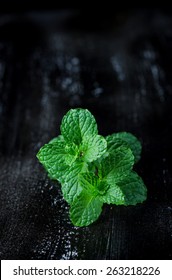 Pepper Mint Leaves On Black Wood Background