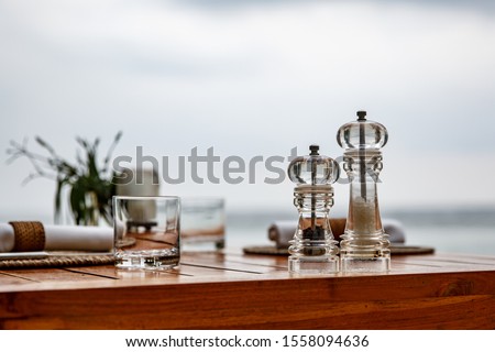 Pepper and salt shaker on the table of a coastal cafe