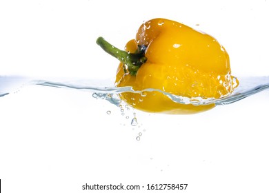 Pepper In Spray Of Water. Juicy Peach With Splash On White Background.