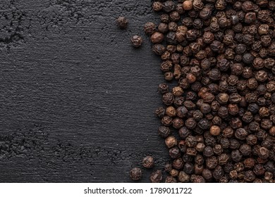 Peppercorn background. Dry black pepper seeds. Top view.On a black background. free space for your text. - Shutterstock ID 1789011722