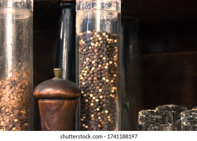 peppercorns in a glass tube, closeup of spices in a traditional italian restaurant