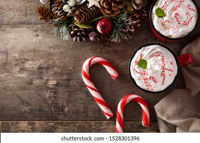 Peppermint coffee mocha decorated with candy canes for Christmas on wooden table. Top view. Copy space - Powered by Shutterstock