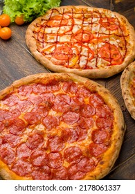 Pepperoni Pizza With Cheese, Pizza With Ham And Mushrooms, Pizza With Chicken, Tomatoes And Bbq Sauce On Wooden Table Vertical